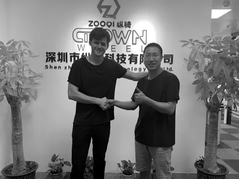 Bennett Harris shaking hands with a supplier at Crown Wheel in Shenzhen