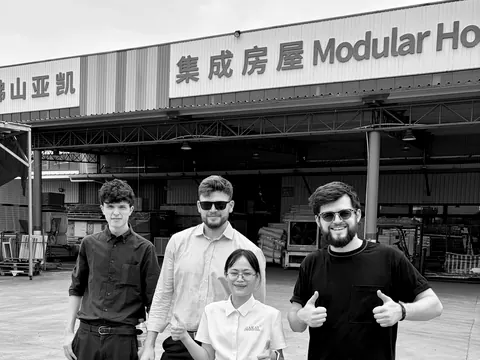 Bennett Harris and colleagues outside a modular housing factory, August 2026